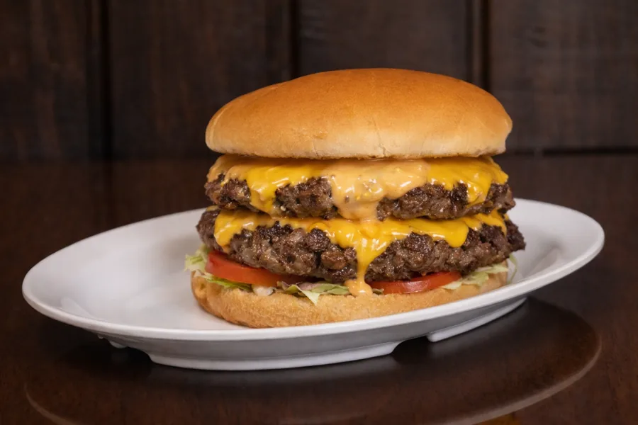 A double cheeseburger stacked with American cheese