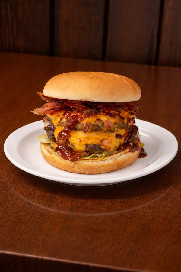 Towering Lone Star Stacker burger with double beef patties, cheese and crispy toppings